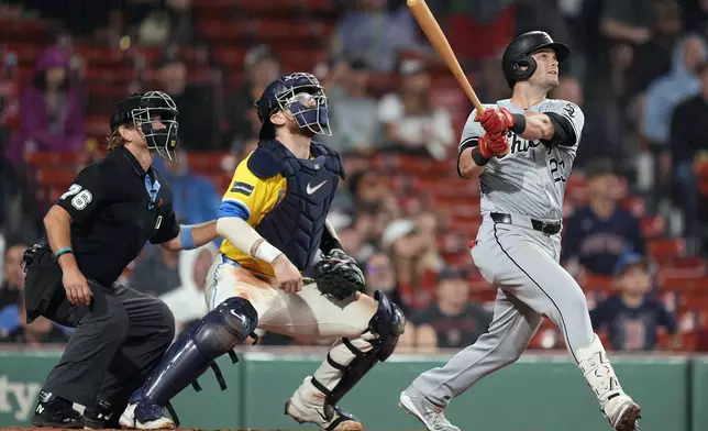 Chicago White Sox's Andrew Benintendi (23) watches his three-run home run in front of Boston Red Sox catcher Danny Jansen during the seventh inning of a baseball game, Saturday, Sept. 7, 2024, in Boston. (AP Photo/Michael Dwyer)