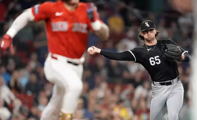 Chicago White Sox starting pitcher Davis Martin (65) throws to first base on a groundout by Boston Red Sox's Jarren Duran, left, during the third inning of a baseball game, Friday, Sept. 6, 2024, in Boston. (AP Photo/Michael Dwyer)