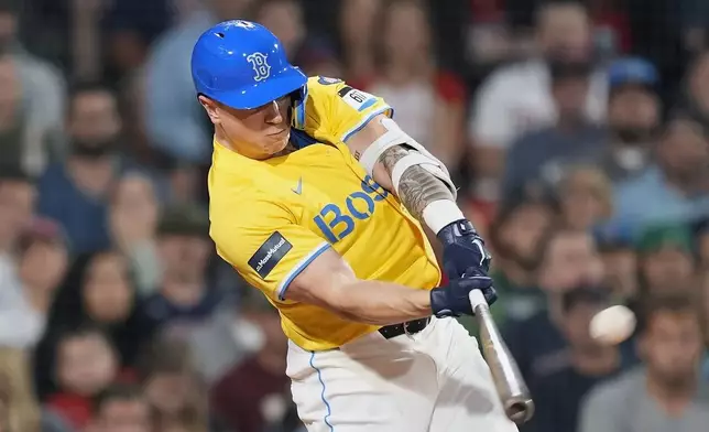 Boston Red Sox's Tyler O'Neill hits a two-run home run during the first inning of a baseball game against the Chicago White Sox, Saturday, Sept. 7, 2024, in Boston. (AP Photo/Michael Dwyer)