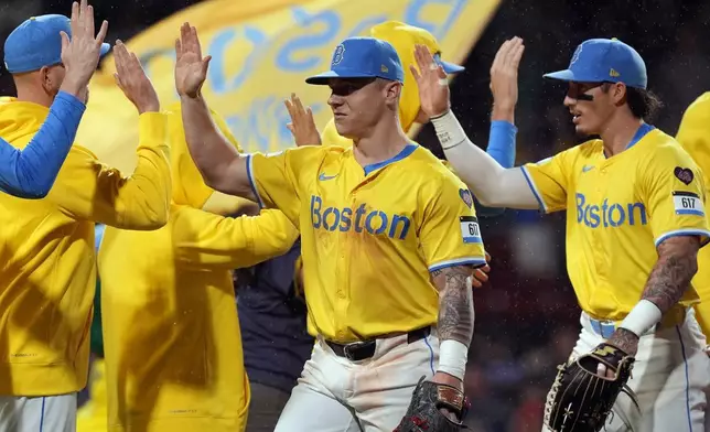 Boston Red Sox's Tyler O'Neill, center, and Jarren Duran, right, celebrate with teammates after defeating the Chicago White Sox during a baseball game, Saturday, Sept. 7, 2024, in Boston. (AP Photo/Michael Dwyer)