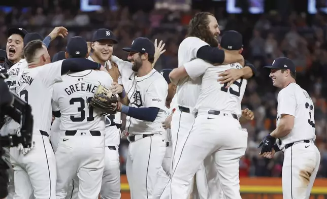 The Detroit Tigers celebrate after defeating the Chicago White Sox to win a wildcard spot in the Major League Baseball playoffs Friday, Sept. 27, 2024, in Detroit. (AP Photo/Duane Burleson)