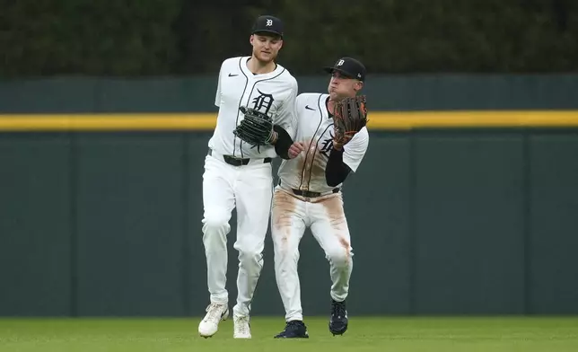 Detroit Tigers right fielder Kerry Carpenter, right, catches a Chicago White Sox's Andrew Benintendi fly ball as center fielder Parker Meadows, left, makes contact in the third inning of a baseball game, Saturday, Sept. 28, 2024, in Detroit. (AP Photo/Paul Sancya)