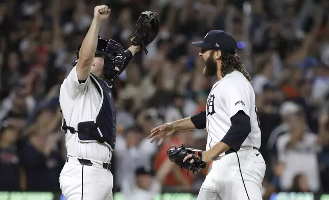 Detroit Tigers catcher Jake Rogers celebrates with closer Jason Foley after defeating the Chicago White Sox to make the playoffs in a baseball game, Friday, Sept. 27, 2024, in Detroit. (AP Photo/Duane Burleson)