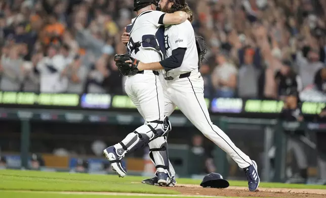 Detroit Tigers catcher Jake Rogers, left, and relief pitcher Jason Foley celebrate after the ninth inning of a baseball game against the Chicago White Sox, Friday, Sept. 27, 2024, in Detroit. (AP Photo/Carlos Osorio)