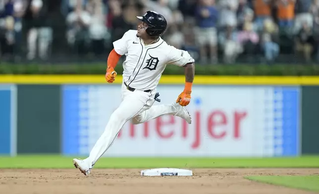 Detroit Tigers' Andy Ibáñez rounds second after a misplay by the centerfielder during the seventh inning of a baseball game against the Chicago White Sox, Friday, Sept. 27, 2024, in Detroit. (AP Photo/Carlos Osorio)