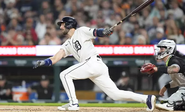 Detroit Tigers' Matt Vierling hits a sacrifice fly to score Parker Meadows during the fifth inning of a baseball game, Friday, Sept. 27, 2024, in Detroit. (AP Photo/Carlos Osorio)