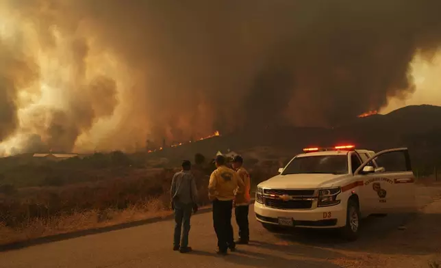 Crews monitor the Airport Fire Tuesday, Sept. 10, 2024, in El Cariso, an unincorporated community in Riverside County, Calif. (AP Photo/Eric Thayer)