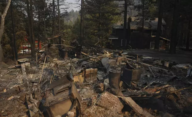 A fire-ravaged property is seen after the Bridge Fire swept through, Thursday, Sept. 12, 2024, in Wrightwood, Calif. (AP Photo/Eric Thayer)