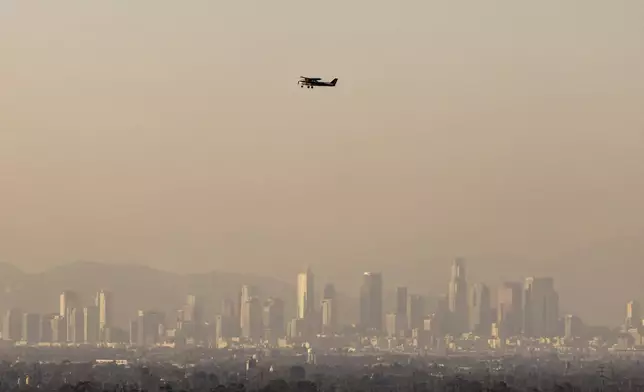 Haze from various wildfires hangs over the downtown skyline Wednesday, Sept. 11, 2024, in Los Angeles. (AP Photo/Etienne Laurent)