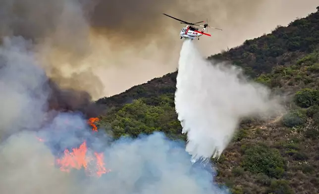 Firefighters battle the Airport Fire along Trabuco Creek Road in Trabuco Canyon, Calif., on Monday, Sept. 9, 2024. (Jeff Gritchen/The Orange County Register via AP)