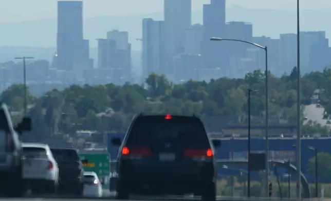 The skyline of downtown is obscured by smoke carried into the Rocky Mountain region from wildfires near Los Angeles, Thursday, Sept. 12, 2024, in Denver. (AP Photo/David Zalubowski)