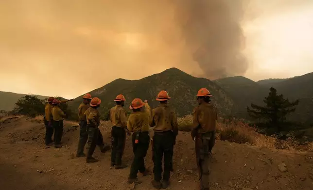 Members of the Mill Creek Hotshots monitor the Line Fire Monday, Sept. 9, 2024, near Angelus Oaks, Calif. (AP Photo/Gregory Bull)