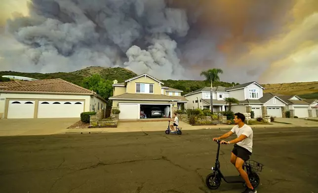 Smoke from the Airport Fire rises behind Meander Lane in Trabuco Canyon, Calif., on Monday, Sept. 9, 2024. (Jeff Gritchen/The Orange County Register via AP)