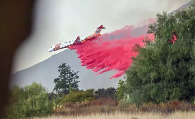 An airplane drops retardant on the Airport Fire in Trabuco Canyon, Calif., on Monday, Sept. 9, 2024. (Jeff Gritchen/The Orange County Register via AP)