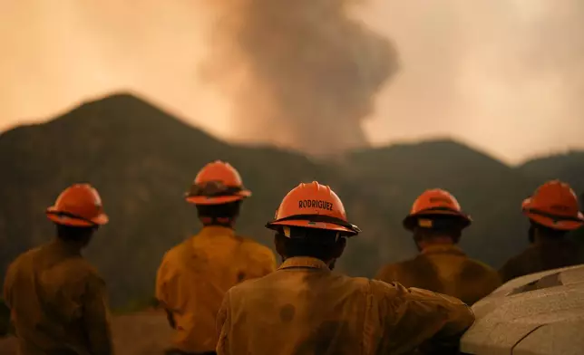 Members of the Mill Creek Hotshots monitor the Line Fire Monday, Sept. 9, 2024, near Angelus Oaks, Calif. (AP Photo/Gregory Bull)