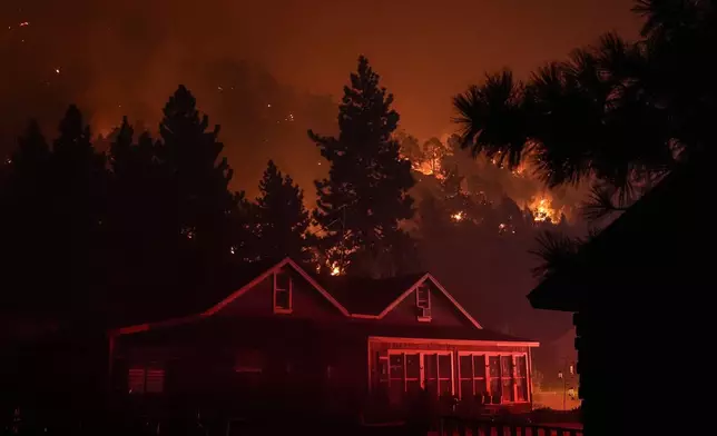 Scorched trees smolder during the Bridge Fire in Wrightwood, Calif., Wednesday, Sept. 11, 2024. (AP Photo/Jae C. Hong)