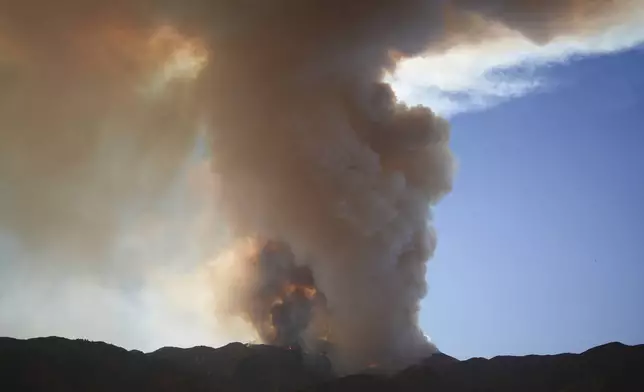 A plume of smoke created by the Airport Fire is seen on a mountain top Tuesday, Sept. 10, 2024, in Temescal Valley, Calif. (AP Photo/Eric Thayer)