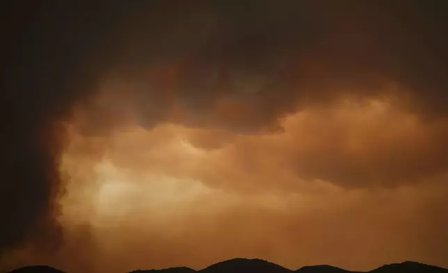 Smoke from the Airport Fire fills the air Tuesday, Sept. 10, 2024, in El Cariso, an unincorporated community in Riverside County, Calif. (AP Photo/Eric Thayer)