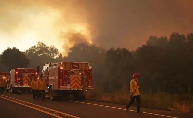 Firefighters monitor the Airport Fire as it advances Tuesday, Sept. 10, 2024, in El Cariso, an unincorporated community in Riverside County, Calif. (AP Photo/Eric Thayer)