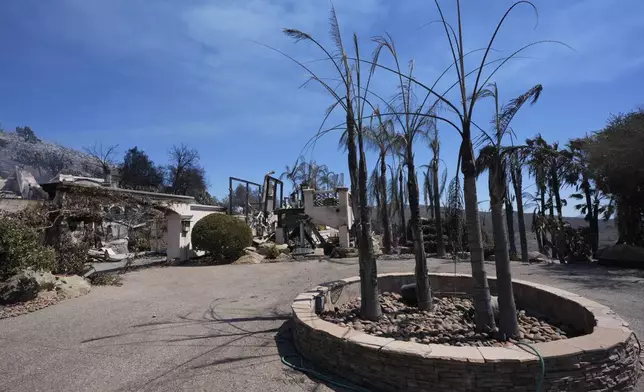 A fire-ravaged property is seen after the Airport Fire swept through Wednesday, Sept. 11, 2024, in El Cariso Village, in unincorporated Riverside, County, Calif. (AP Photo/Gregory Bull)