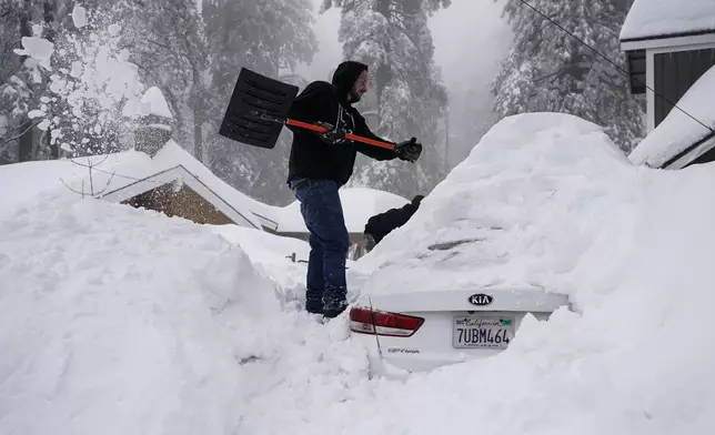 FILE - Kenny Rybak shovels snow around his car in Running Springs, Calif., Tuesday, Feb. 28, 2023. (AP Photo/Jae C. Hong, File)