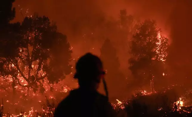 The Bridge Fire burns in Wrightwood, Calif., Tuesday, Sept. 10, 2024. (AP Photo/Jae C. Hong)