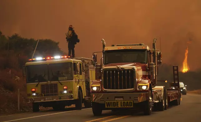 Firefighters monitor the Airport Fire as it advances Tuesday, Sept. 10, 2024, in El Cariso, an unincorporated community in Riverside County, Calif. (AP Photo/Eric Thayer)