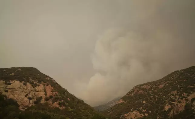 A plume of smoke from the Line Fire is seen Monday, Sept. 9, 2024, outside of Forest Falls, Calif. (AP Photo/Eric Thayer)