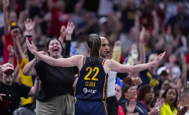 Indiana Fever guard Caitlin Clark (22) celebrates after a three-point basket against the Dallas Wings in the first half of a WNBA basketball game in Indianapolis, Sunday, Sept. 15, 2024. (AP Photo/Michael Conroy)