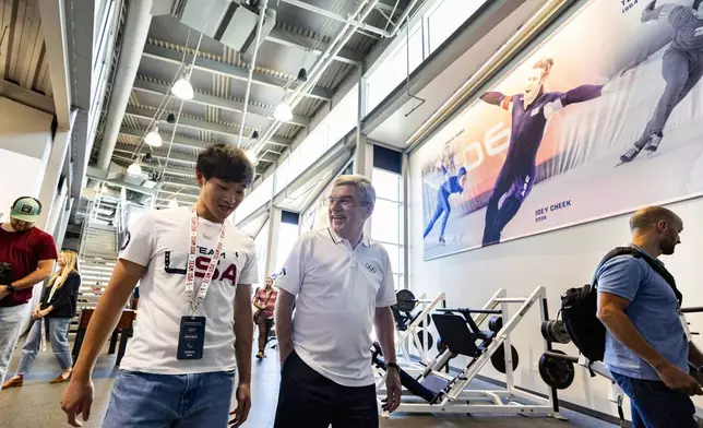 International Olympic Committee President Thomas Bach, center right, talks with Olympic speed skater Andrew Heo as they tour the U.S. Speedskating Speed Factory training center at the Utah Olympic Oval in Kearns, Utah, Saturday, Sept. 28. 2024./The Deseret News via AP)