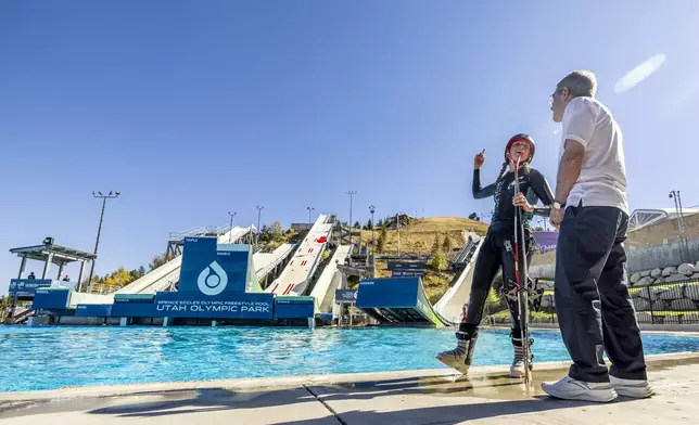 Freestyle aerial skier Cate McEneany, of Park City, talks with International Olympic Committee President Thomas Bach at the Spence Eccles Olympic Freestyle Pool within the Utah Olympic Park in Park City, Utah, Saturday, Sept. 28. 2024. (Isaac Hale/The Deseret News via AP)