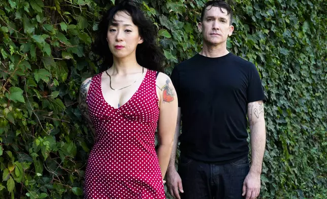 Angela Seo, left, and Jamie Stewart of the band Xiu Xiu pose for a portrait in Berlin, Germany, Wednesday, Aug. 28, 2024. (AP Photo/Markus Schreiber)