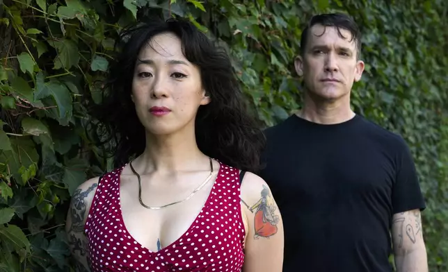 Angela Seo, left, and Jamie Stewart of the band Xiu Xiu pose for a portrait in Berlin, Germany, Wednesday, Aug. 28, 2024. (AP Photo/Markus Schreiber)