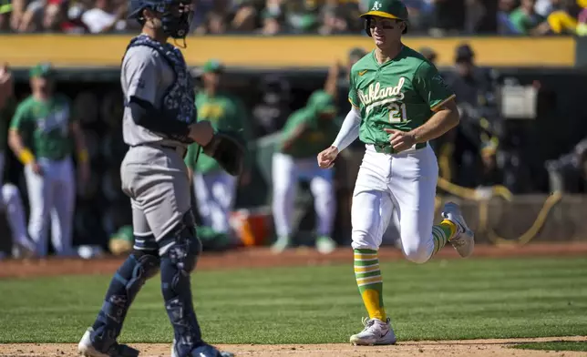 Oakland Athletics' Tyler Soderstrom (21) scores during the sixth inning of a baseball game against the New York Yankees in Oakland, Calif., Sunday, Sept. 22, 2024. (AP Photo/Nic Coury)