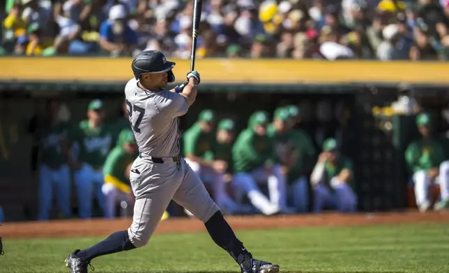 New York Yankees' Giancarlo Stanton hits during the seventh inning of a baseball game against the Oakland Athletics in Oakland, Calif., Sunday, Sept. 22, 2024. (AP Photo/Nic Coury)