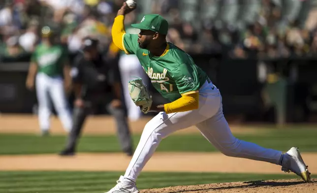 Oakland Athletics pitcher Michel Otañez throws during the seventh inning of a baseball game against the New York Yankees in Oakland, Calif., Sunday, Sept. 22, 2024. (AP Photo/Nic Coury)