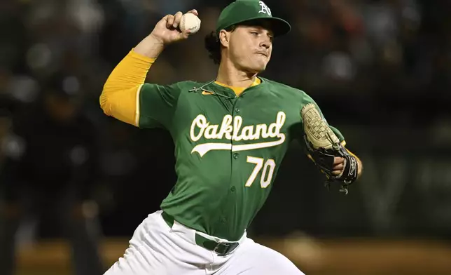 Oakland Athletics pitcher J.T. Ginn throws against the New York Yankees during the fifth inning of a baseball game Friday, Sept. 20, 2024, in Oakland, Calif. (AP Photo/Eakin Howard)