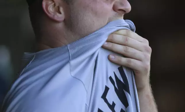 New York Yankees starting pitcher Clarke Schmidt reacts in the dugout after being pulled during the fifth inning of a baseball game against the Chicago Cubs in Chicago, Saturday, Sept. 7, 2024. (AP Photo/Paul Beaty)