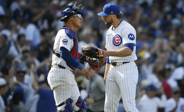 Chicago Cubs closing pitcher Porter Hodge, right, celebrates with catcher Christian Betancourt, left, after defeating the New York Yankees 2-1 in a baseball game in Chicago, Sunday, Sept. 8, 2024. (AP Photo/Paul Beaty)