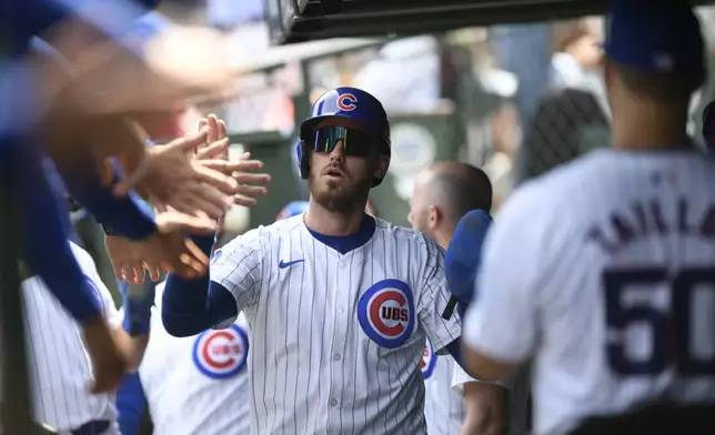 Chicago Cubs' Cody Bellinger celebrates with teammates in the dugout after scoring on a two-RBI single by Isaac Paredes during the first inning of a baseball game against the New York Yankees in Chicago, Sunday, Sept. 8, 2024. (AP Photo/Paul Beaty)