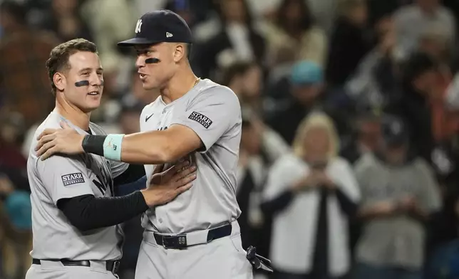 New York Yankees' Anthony Rizzo, left, greets designated hitter Aaron Judge, right, as they celebrate clinching a playoff spot after a 2-1 win over the Seattle Mariners in a baseball game Wednesday, Sept. 18, 2024, in Seattle. (AP Photo/Lindsey Wasson)