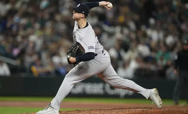 New York Yankees relief pitcher Clay Holmes throws against the Seattle Mariners during the eighth inning of a baseball game Wednesday, Sept. 18, 2024, in Seattle. (AP Photo/Lindsey Wasson)