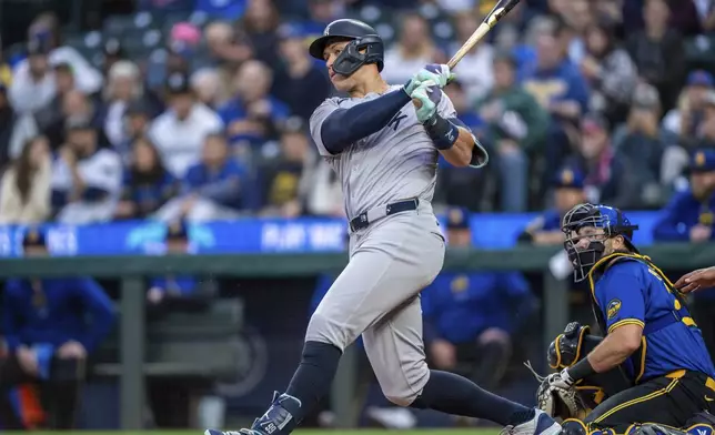 New York Yankees' Aaron Judge hits a two-run designated hitter during the first inning of a baseball game against the Seattle Mariners, Tuesday, Sept. 17, 2024, in Seattle. (AP Photo/Stephen Brashear)