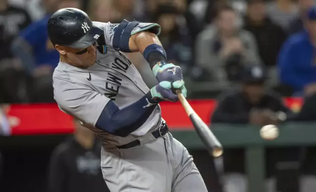 New York Yankees' Aaron Judge hits a two-run single during the second inning of a baseball game against the Seattle Mariners, Tuesday, Sept. 17, 2024, in Seattle. (AP Photo/Stephen Brashear)