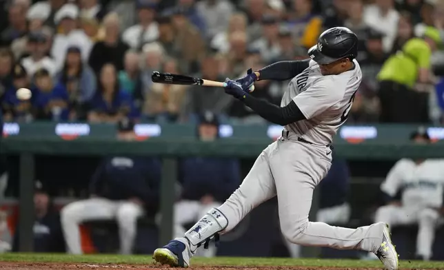 New York Yankees' Juan Soto hits a double against the Seattle Mariners during the third inning of a baseball game Wednesday, Sept. 18, 2024, in Seattle. (AP Photo/Lindsey Wasson)