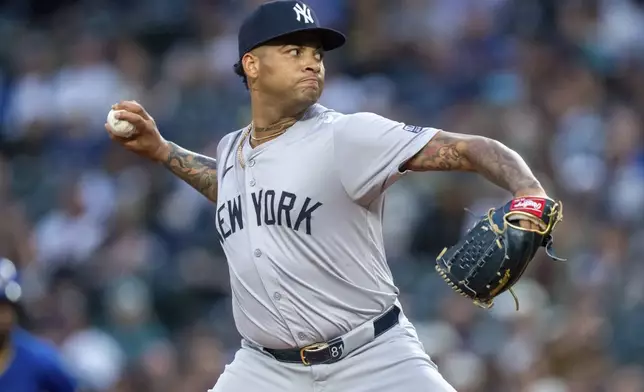 New York Yankees starter Luis Gil delivers a pitch during the first inning of a baseball game against the Seattle Mariners, Tuesday, Sept. 17, 2024, in Seattle. (AP Photo/Stephen Brashear)