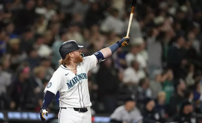 Seattle Mariners' Justin Turner reacts to hitting a solo home run against the New York Yankees during the eighth inning of a baseball game Wednesday, Sept. 18, 2024, in Seattle. (AP Photo/Lindsey Wasson)