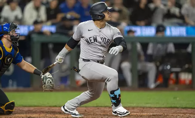 New York Yankees' Jasson Dominguez hits a solo home run during the fifth inning of a baseball game against the Seattle Mariners, Tuesday, Sept. 17, 2024, in Seattle. (AP Photo/Stephen Brashear)