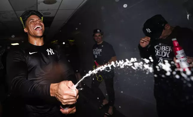 New York Yankees right fielder Juan Soto celebrates clinching a playoff spot after a 2-1 win in 10 innings over the Seattle Mariners in a baseball game Wednesday, Sept. 18, 2024, in Seattle. (AP Photo/Lindsey Wasson)