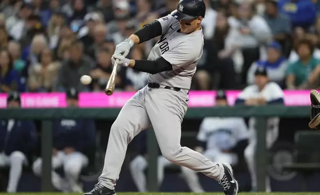 New York Yankees' Anthony Rizzo hits an RBI single to score Jasson Domínguez against the Seattle Mariners during the second inning of a baseball game Wednesday, Sept. 18, 2024, in Seattle. (AP Photo/Lindsey Wasson)